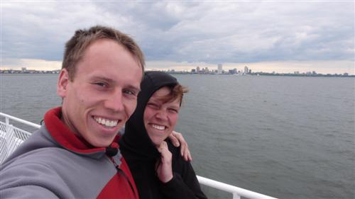 Auf der Faehre pustet uns der Wind fast weg. Im Hintergrund sieht man die Silhouette von Milwaukee.